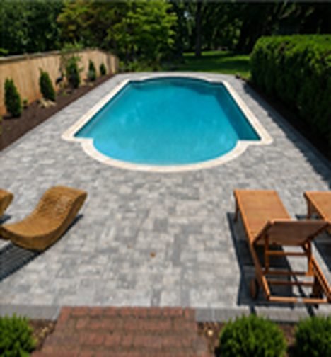 After: pool surrounded by a new gray paver patio
