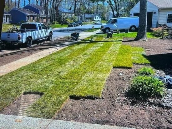 MV Landscaping Services truck and van at a sod installation job
