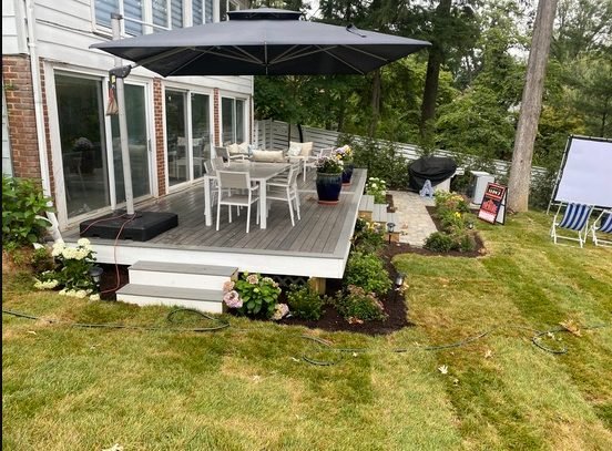 Wood deck with outdoor furniture and umbrella