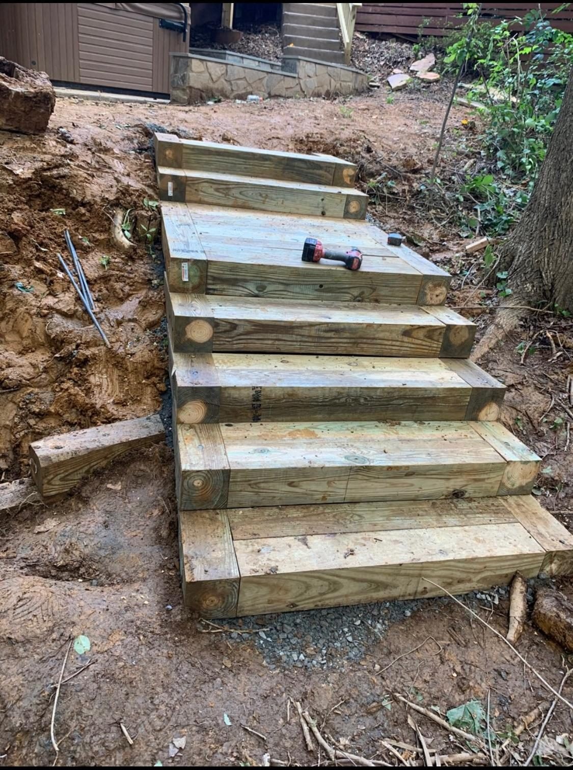 Wood timber steps built into a sloped backyard