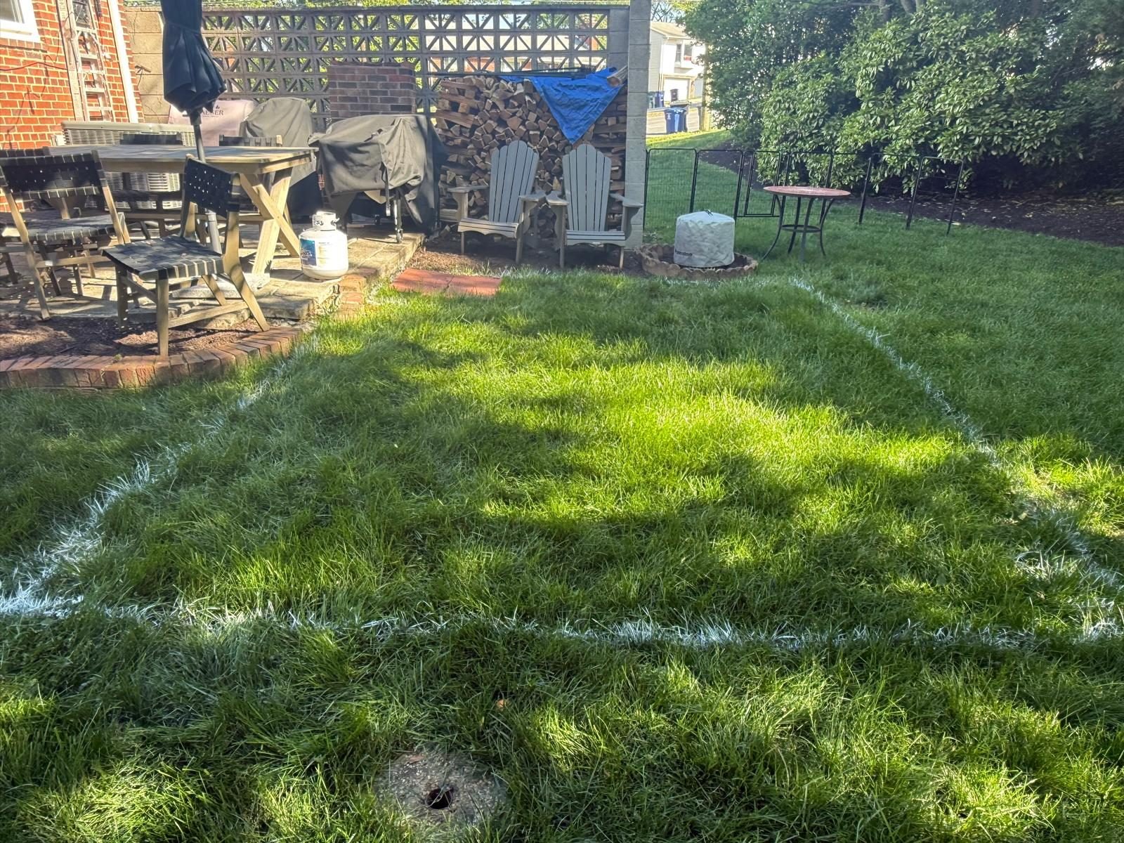 Freshly mowed lawn with striped pattern and backyard seating area