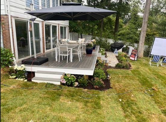 Wood deck with outdoor furniture and umbrella